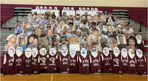 Cardboard cutouts of family and friends of student athletes fill the stands in the gymnasium. The cutouts are part of the Fill the Stands program which works to give athletes virtual fans to play for during the pandemic. The number of spectators has been limited since sports returned in March. 