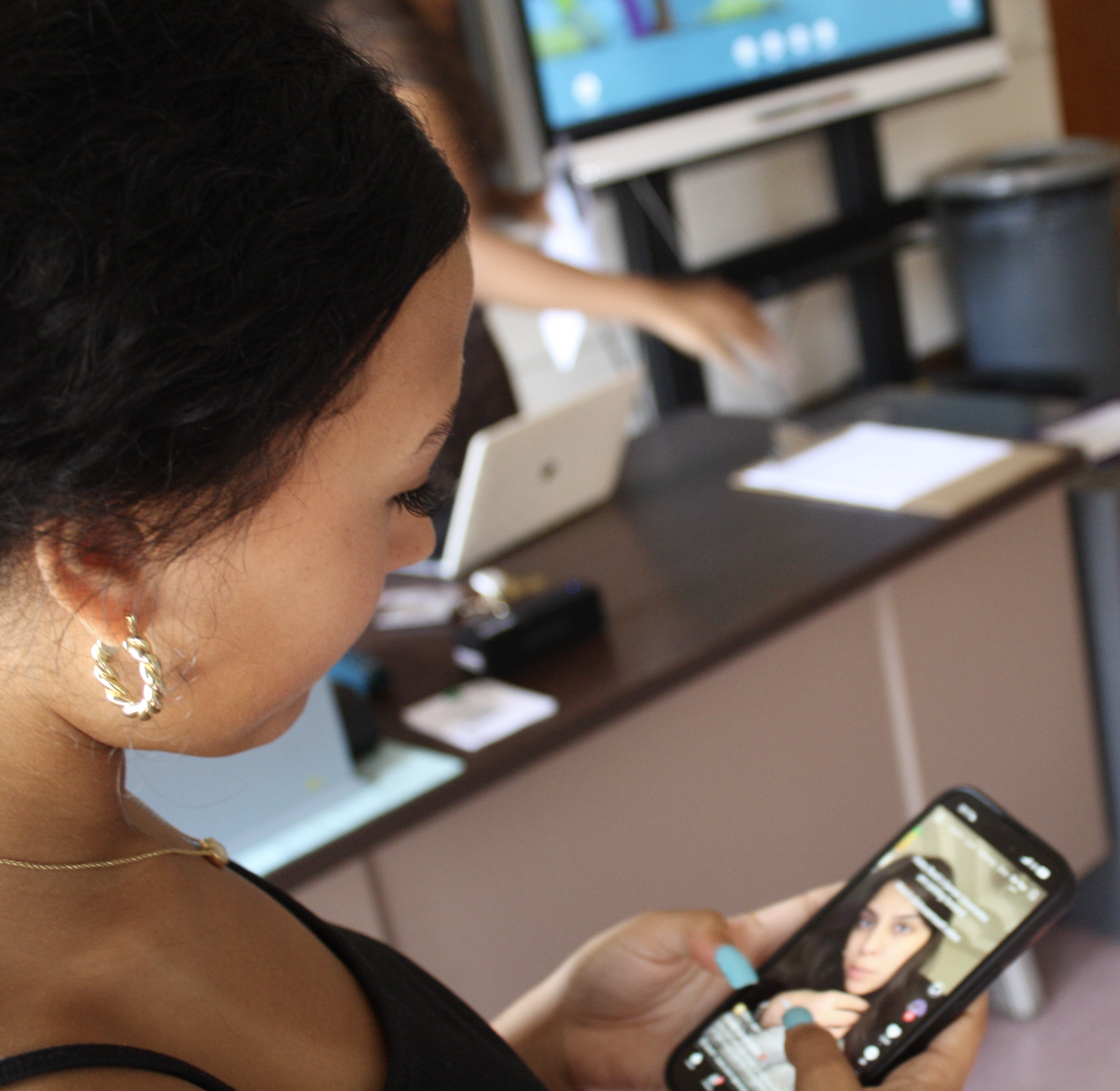 A student scrolls on their phone after the school day is complete.